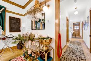 a hallway with a dining room with a chandelier at The Twin Lions: Bespoke Travel Lodge w/ Speakeasy* in Chicago