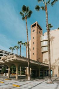 a building with palm trees in front of it at Courtyard by Marriott Los Angeles LAX / Century Boulevard in Los Angeles