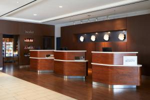 a lobby of a hotel with wooden counter tops at Courtyard by Marriott Los Angeles LAX / Century Boulevard in Los Angeles