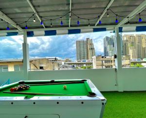 a pool table in a room with a view of a city at k4 be chill *Wongwianyai BTS_80m*Family&Friend* in Godown