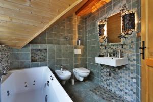 a bathroom with a tub and a toilet and a sink at Medvědí skála in Čeladná