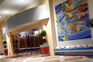 a lobby of a building with a large painting on the wall at Renaissance Orlando at SeaWorld® in Orlando