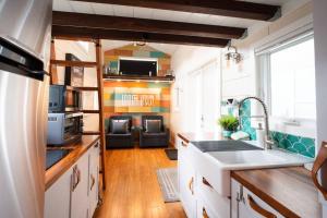 a kitchen with a sink and a counter top at Teal Tiny Home Creek Views in San Luis Obispo