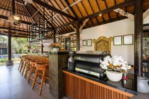 a restaurant with a bar with stools at Svarga Bebek Villas in Ubud
