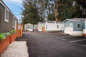 a parking lot with a row of mobile homes at Teal Tiny Home Creek Views in San Luis Obispo
