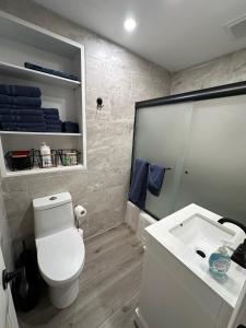 a bathroom with a white toilet and a sink at 2BR Gem: Modern Comfort & Style in Cheyenne