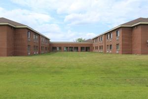 沃基根的住宿－沃基根紅屋頂客棧，一座空的学校建筑,有大草地庭院