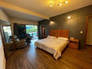 a bedroom with a bed and a chair in it at Casa NAJ BALAM in Bacalar +51 photos