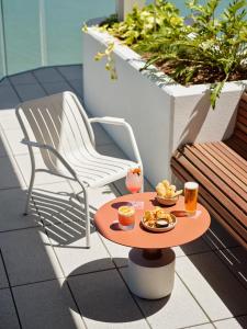a table with a plate of food and drinks on a patio at Ardo in Townsville