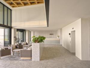 a lobby with couches and chairs in a building at Ardo in Townsville