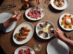 a wooden table with plates of food on it at Ardo in Townsville