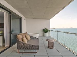 a balcony with a couch and a view of the water at Ardo in Townsville