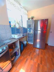 uma cozinha com frigorífico e piso em madeira em Fernanda apartment em Arequipa