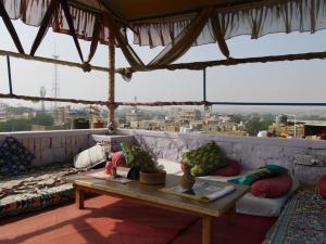 a living room with a table and a couch at Rumis Guest House in Jaisalmer