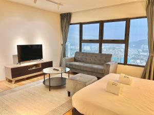 a hotel room with two beds a couch and a television at Entire Loft Hosted by Forave Home Wi-Fi 500mbps in Kuala Lumpur
