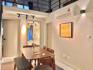 a dining room with a table and chairs at Entire Loft Hosted by Forave Home Wi-Fi 500mbps in Kuala Lumpur