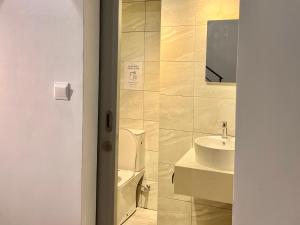 a bathroom with a toilet and a sink at Entire Loft Hosted by Forave Home Wi-Fi 500mbps in Kuala Lumpur