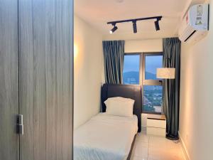 a small bedroom with a bed and a window at Entire Loft Hosted by Forave Home Wi-Fi 500mbps in Kuala Lumpur