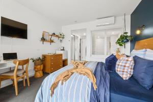 a bedroom with a bed and a desk with a computer at Resort on the Beach Dual Unit 5203 in Kingscliff