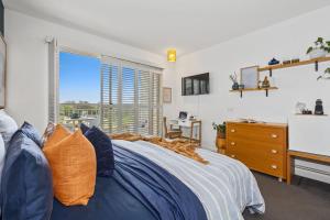 a bedroom with a blue bed and a window at Resort on the Beach Dual Unit 5203 in Kingscliff