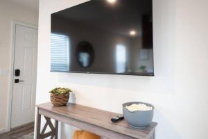 a mirror on a wall above a wooden table at 2 Bedroom Coastal Home in SLO in San Luis Obispo