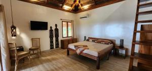 Ένα ή περισσότερα κρεβάτια σε δωμάτιο στο Casa Marisa Palawan