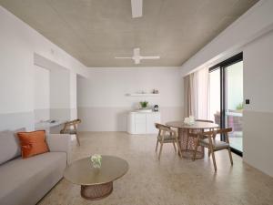 a living room with a couch and a table at Ardo in Townsville