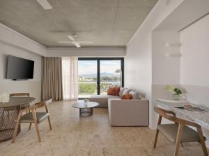 a living room with a couch and a table at Ardo in Townsville
