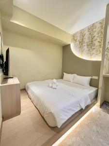 Ένα ή περισσότερα κρεβάτια σε δωμάτιο στο Asimmy Hotel