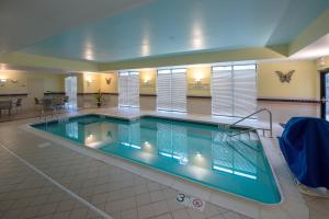 a large swimming pool in a building at SpringHill Suites by Marriott Greensboro in Greensboro