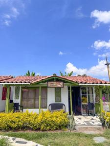 ein kleines weißes Haus mit rotem Dach in der Unterkunft Las Cabañitas in Pereira