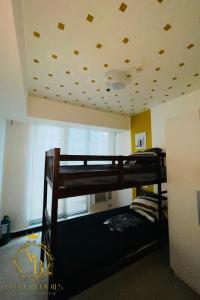 two bunk beds in a room with a ceiling at Azure Urban Resort near NAIA Airport in Manila