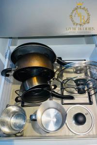 a stove top with a pot and pans on it at Azure Urban Resort near NAIA Airport in Manila