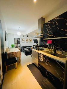 a kitchen with a sink and a stove top oven at Azure Urban Resort near NAIA Airport in Manila