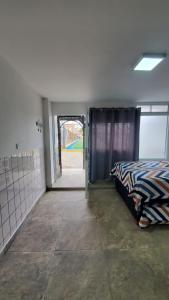a bedroom with a bed and an open door at Sanbar House in San Bartolo