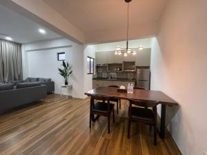 a dining room and living room with a wooden table at Genting View Resort in Genting Highlands