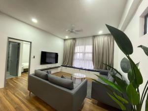 a living room with a couch and a tv at Genting View Resort in Genting Highlands