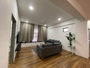 a living room with a couch and a television at Genting View Resort in Genting Highlands