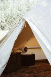a white tent with a lamp on a dresser at Village Del Mar - Corse in Solaro