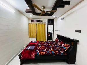 a bedroom with a bed and a ceiling fan at Crystal dew in Visakhapatnam
