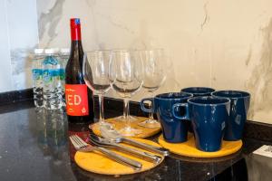 a group of wine glasses and silverware on a counter at Societe Suites By iHost Global in Kuala Lumpur