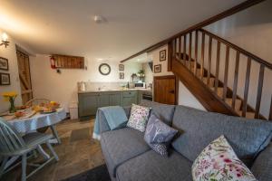a living room with a couch and a table at Crooks in Axbridge