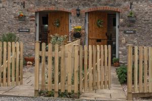 a wooden fence in front of a house at Crooks in Axbridge