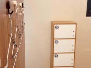 a room with a dresser and a wall with draws at Dreamy Nomads Hostel日月潭背包客 in Yuchi