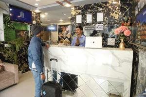 two men standing at a counter in a store at B2L Hills At Tapoavn in Rishīkesh