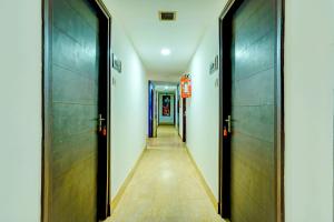 a hallway with two doors and a long corridor at Super OYO Hotel Sunshin Deluxe in Nagpur