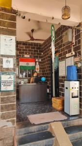 a restaurant with a counter and a brick wall at The goanvibes hostel and cafe in Anjuna