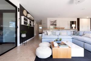 a living room with a blue couch and a table at Hadspen Riverview Retreat: Main House in Hadspen