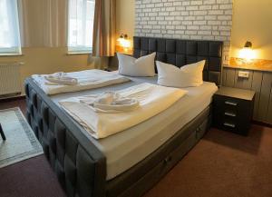 a bedroom with two beds with towels on them at Hotel Carl von Clausewitz in Leipzig