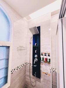 a bathroom with a shower with a black door at 樂陶陶精品民宿 in Taitung City